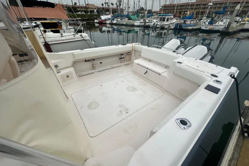 Slide: The Image of 2001 Grady-White Marlin 300 boat deck, docked in a marina with multiple sailboats. - 10