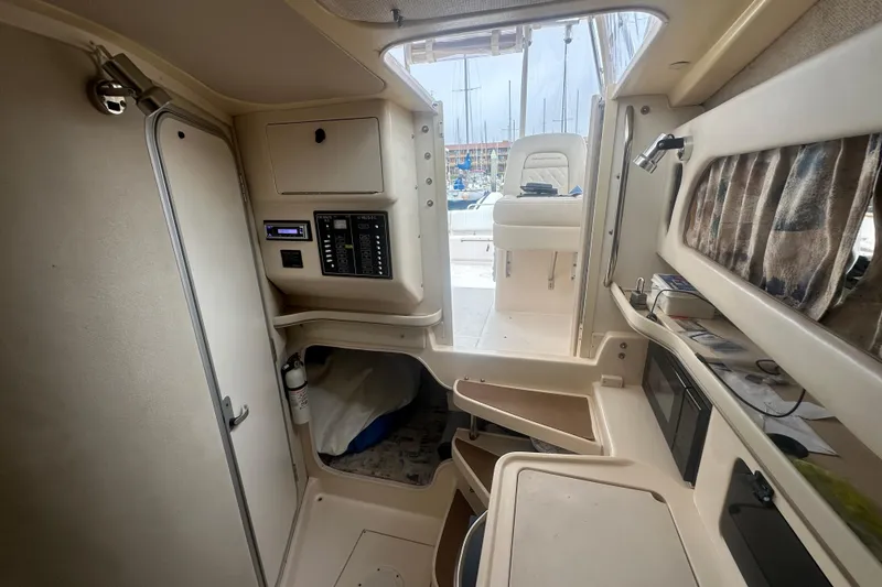 Slide: The Image of 2001 Grady-White Marlin 300 cabin interior with control panel and seating area. - 11