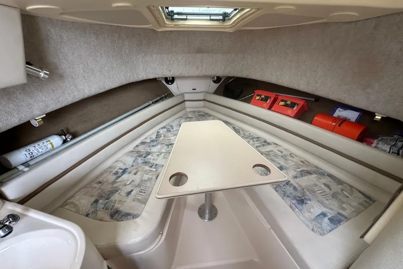 Slide: The Image of 2001 Grady-White Marlin 300 cabin interior with table and seating area. - 12