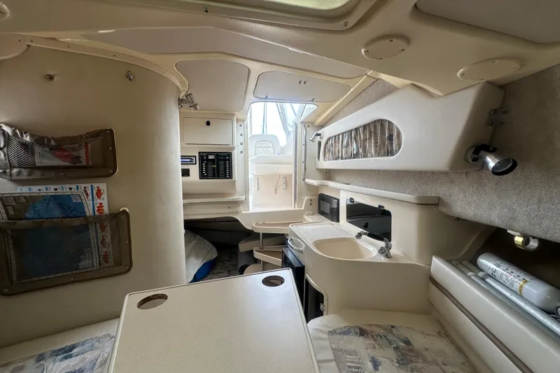 Slide: The Image of Interior of a 2001 Grady-White Marlin 300 boat, featuring a compact cabin layout. - 13