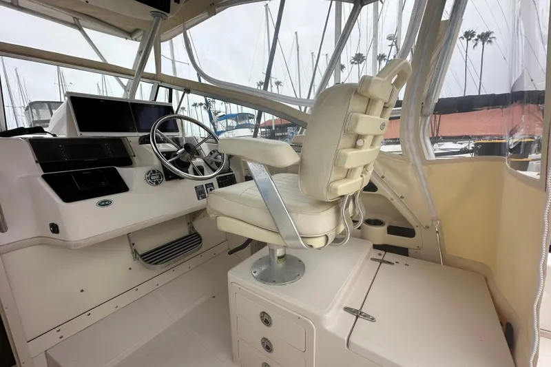 Slide: The Image of 2001 Grady-White Marlin 300 boat cockpit with steering wheel and captain's chair. - 14