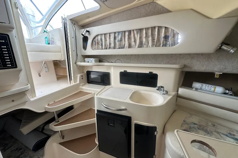 Slide: The Image of Interior of 2001 Grady-White Marlin 300 boat with kitchenette and seating area. - 17