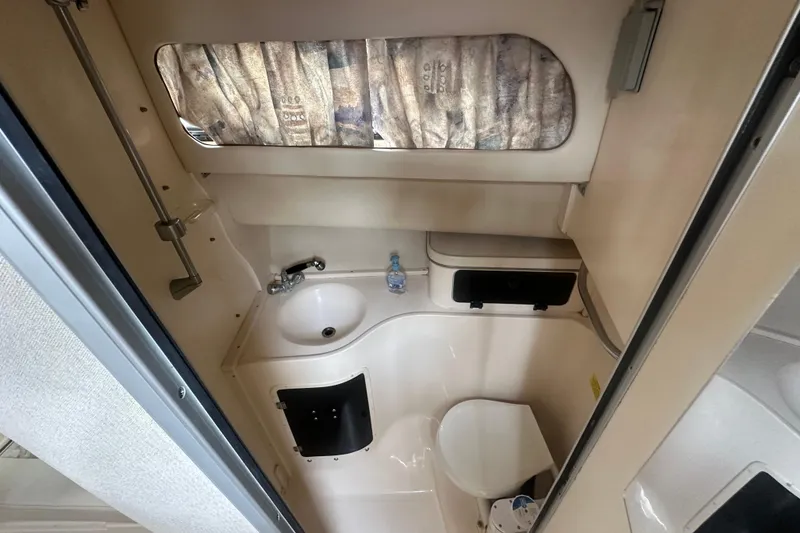 Slide: The Image of 2001 Grady-White Marlin 300 boat bathroom interior with sink and toilet. - 19