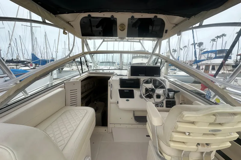 Slide: The Image of Interior view of a 2001 Grady-White Marlin 300 boat, featuring helm and seating area. - 20