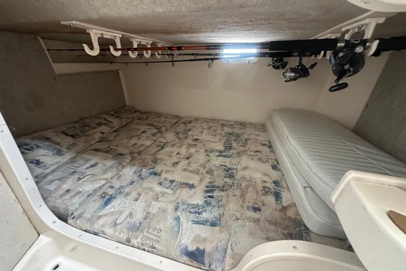 Slide: The Image of Interior cabin of 2001 Grady-White Marlin 300 with fishing rods and bedding. - 22