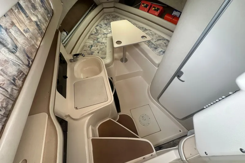 Slide: The Image of 2001 Grady-White Marlin 300 cabin interior with sink, table, and seating area. - 23