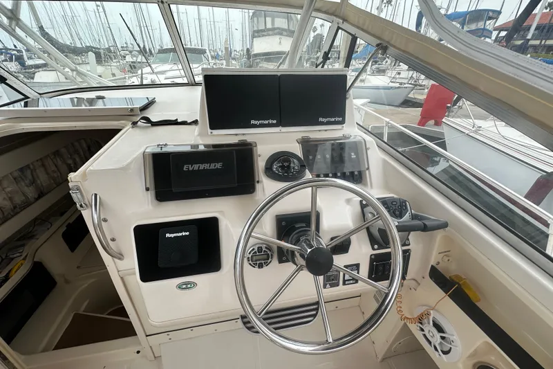 Slide: The Image of Helm of 2001 Grady-White Marlin 300 with Raymarine electronics and Evinrude controls. - 24
