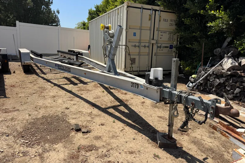 Slide: The Image of Boat trailer for 2001 Grady-White Marlin 300, parked on dirt near storage container. - 26