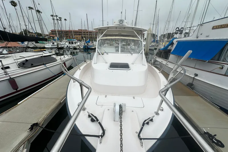 Slide: The Image of 2001 Grady-White Marlin 300 boat docked in a marina with sailboats. - 4