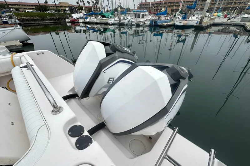 Slide: The Image of 2001 Grady-White Marlin 300 with dual outboard motors docked in a marina. - 8