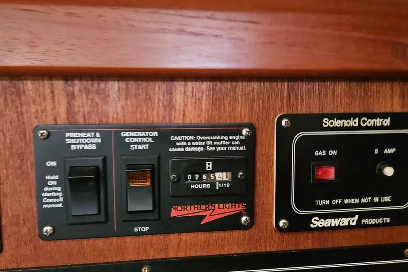 Slide: The Image of Control panel of a 1996 Hunter Legend 40.5 yacht, featuring generator and solenoid controls. - 30