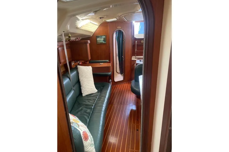 Slide: The Image of Interior of 1996 Hunter Legend 40.5 yacht with wood finish and green seating. - 16