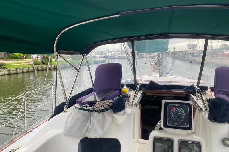 Slide: The Image of Cockpit view of 1996 Hunter Legend 40.5 sailboat with green canopy and navigation instruments. - 6