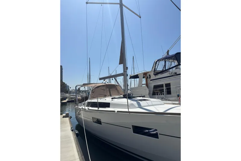 Slide: The Image of 2017 Beneteau Oceanis 38 sailboat docked at marina under clear blue sky. - 13
