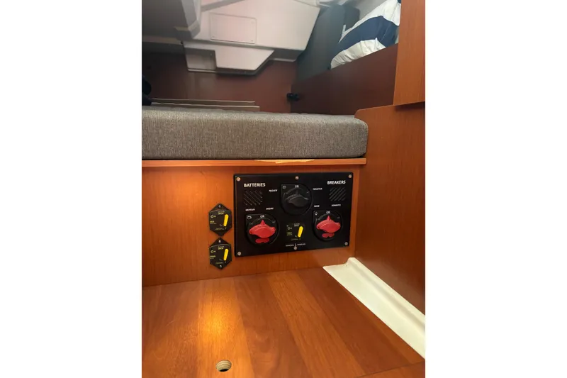 Slide: The Image of Control panel in 2017 Beneteau Oceanis 38 yacht interior, featuring battery and breaker switches. - 19