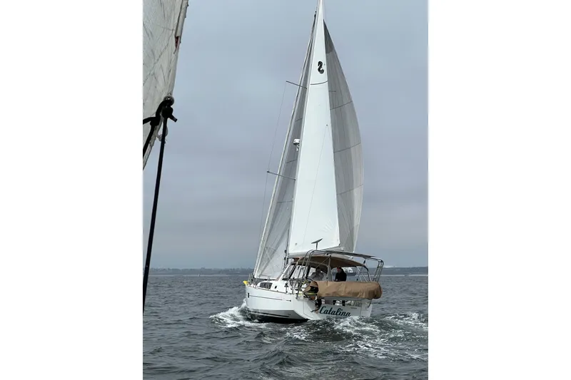 Slide: The Image of 2017 Beneteau Oceanis 38 sailing on open water under cloudy skies. - 2