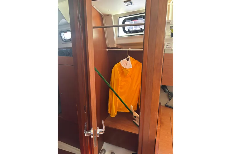 Slide: The Image of Interior closet of 2017 Beneteau Oceanis 38 yacht with yellow jacket hanging. - 22
