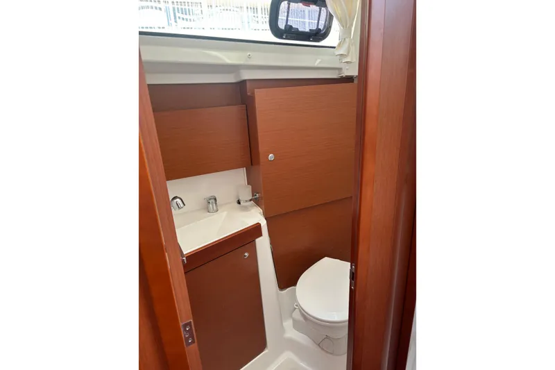 Slide: The Image of Compact bathroom in 2017 Beneteau Oceanis 38 yacht with wooden cabinetry and modern fixtures. - 24