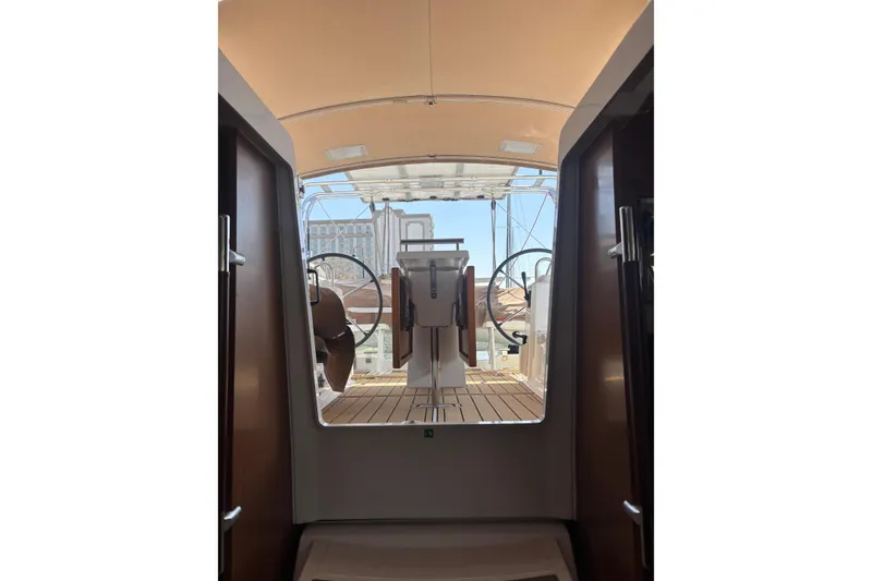 Slide: The Image of Interior view of 2017 Beneteau Oceanis 38 sailboat cockpit with dual steering wheels. - 25