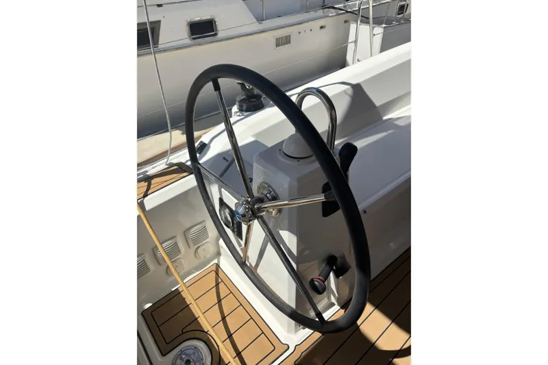 Slide: The Image of Steering wheel of a 2017 Beneteau Oceanis 38 sailboat, featuring teak decking. - 39