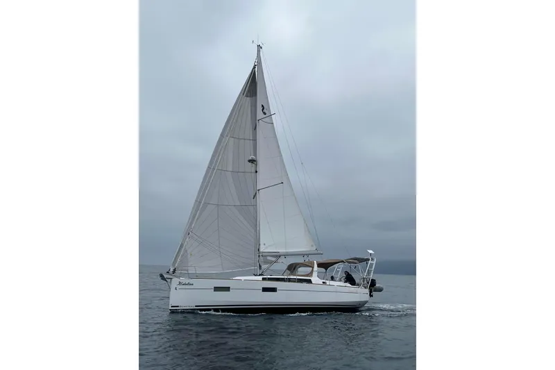 Slide: The Image of 2017 Beneteau Oceanis 38 sailing on open water under cloudy skies. - 4