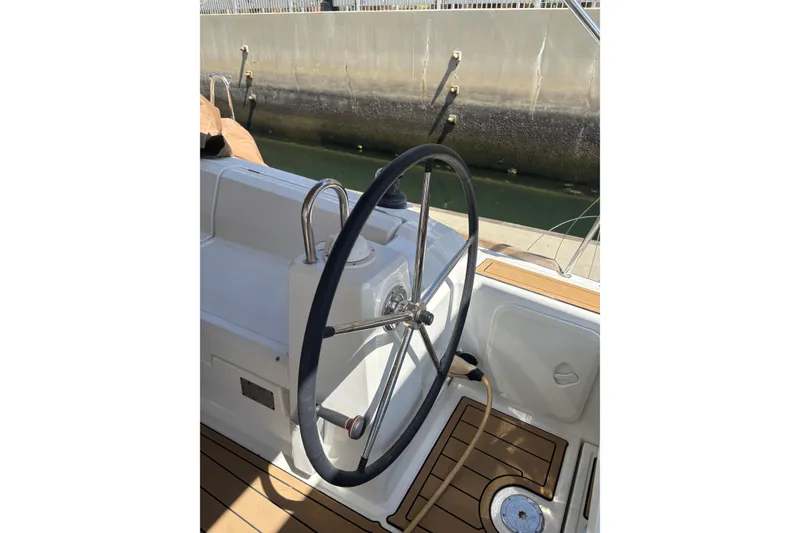 Slide: The Image of Steering wheel of a 2017 Beneteau Oceanis 38 sailboat, docked at a marina. - 40