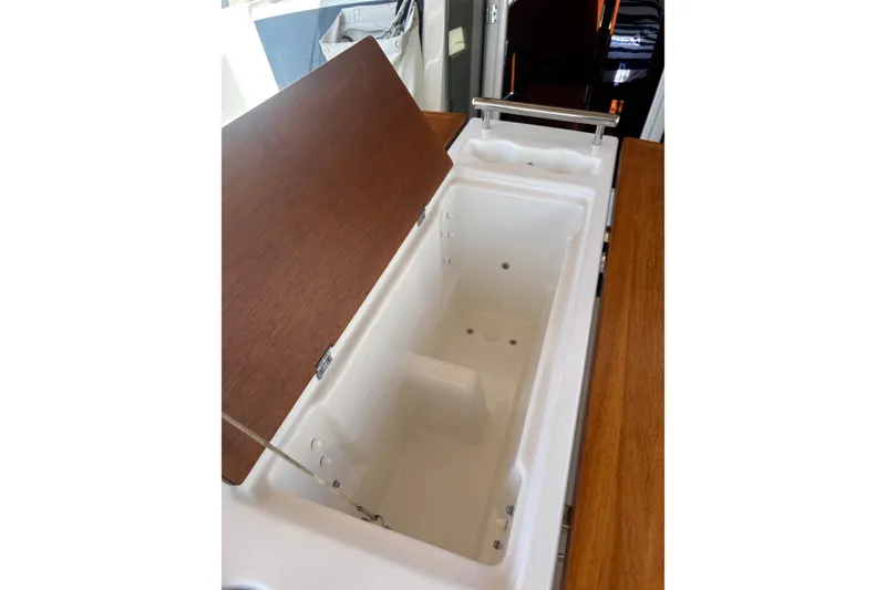 Slide: The Image of Open storage compartment on 2017 Beneteau Oceanis 38 yacht, featuring wooden lid and sleek design. - 41