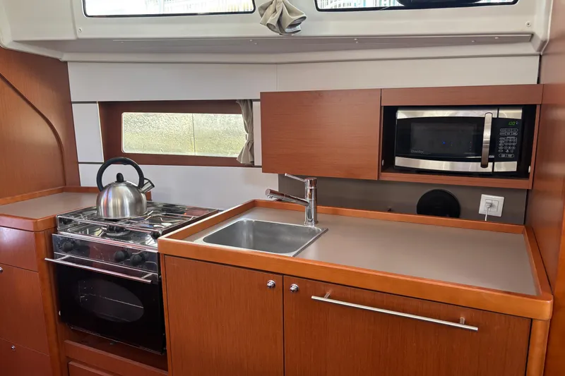 Slide: The Image of Modern kitchen in 2017 Beneteau Oceanis 38 yacht with stove, sink, and microwave. - 43