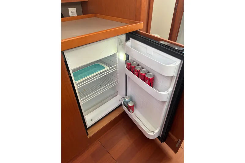 Slide: The Image of Open fridge in 2017 Beneteau Oceanis 38 yacht, stocked with soda cans. - 44