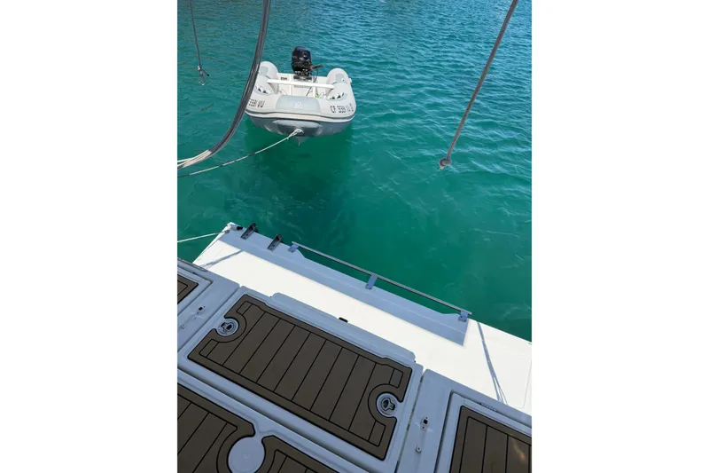 Slide: The Image of Beneteau Oceanis 38 (2017) with dinghy on turquoise water. - 5