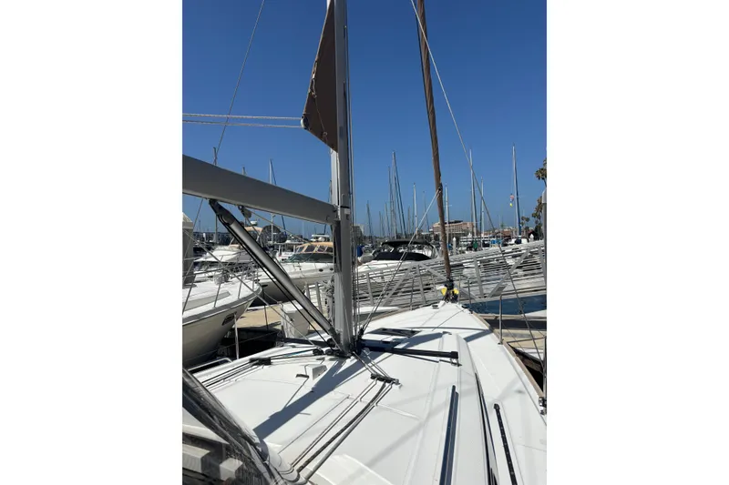 Slide: The Image of 2017 Beneteau Oceanis 38 sailboat docked in a marina under clear blue skies. - 50