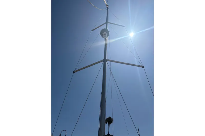 Slide: The Image of Mast of 2017 Beneteau Oceanis 38 sailboat against clear blue sky and sun. - 52