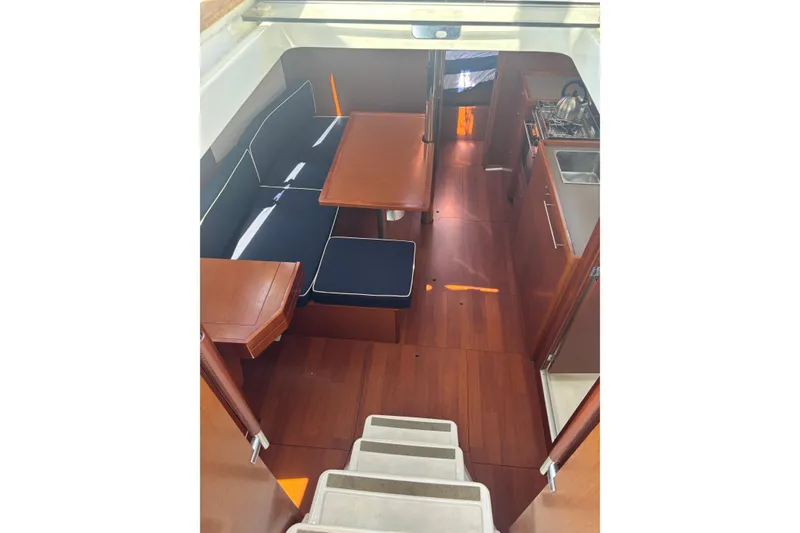 Slide: The Image of Interior of 2017 Beneteau Oceanis 38 sailboat with wood finish and compact kitchen. - 58