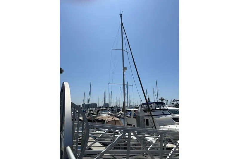 Slide: The Image of 2017 Beneteau Oceanis 38 sailboat docked at a sunny marina. - 63