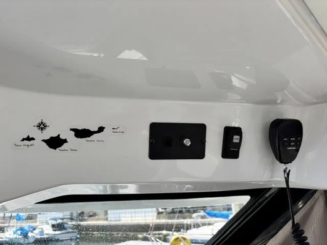 Slide: The Image of Interior view of a Jeanneau NC 895 Offshore with controls and a microphone. - 19