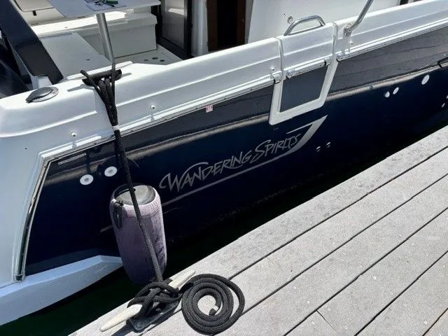 Slide: The Image of A 2019 Jeanneau NC 895 Offshore docked. The name "Wandering Spirits" is visible. - 34