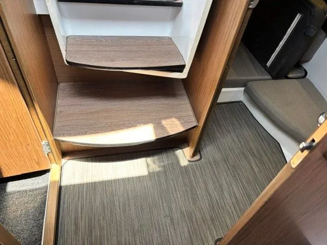 Slide: The Image of Interior of the Jeanneau NC 895 Offshore with wooden steps and carpeted floor. - 27