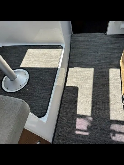 Slide: The Image of Interior of Jeanneau NC 895 Offshore with gray carpeting and seating area. - 24
