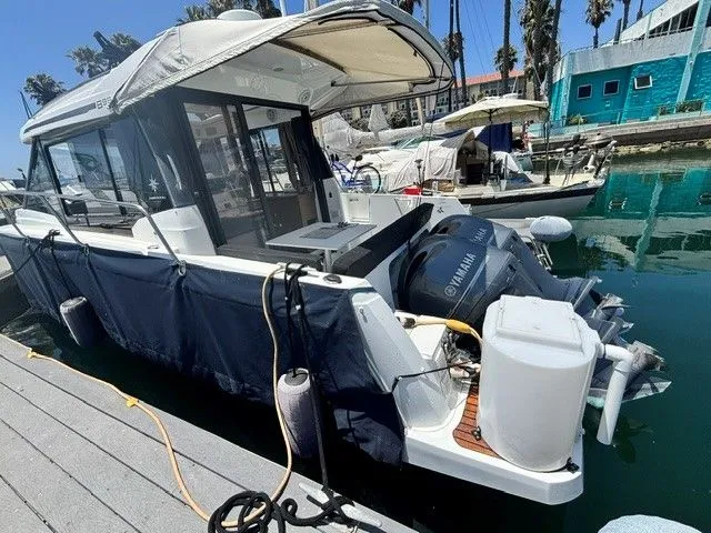Slide: The Image of A 2019 Jeanneau NC 895 Offshore docked. It features a Yamaha outboard motor. - 33