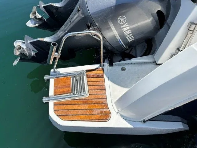 Slide: The Image of Stern of a boat with wooden platform and Yamaha outboard motor. - 16