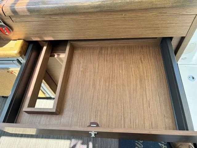 Slide: The Image of Open wooden drawer in a boat, featuring a small compartment. The surroundings are well-lit. - 26