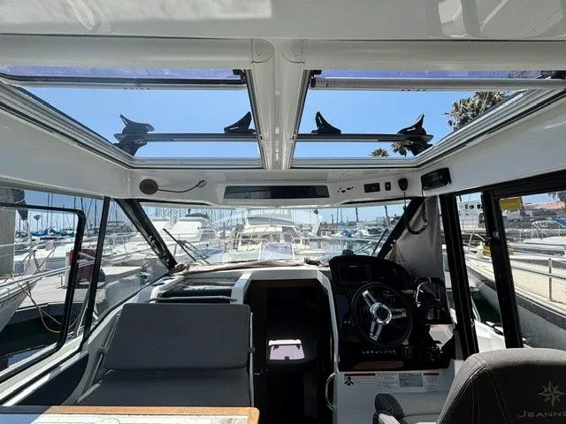 Slide: The Image of Interior view of the Jeanneau NC 895 Offshore with panoramic windows and modern helm station. - 32