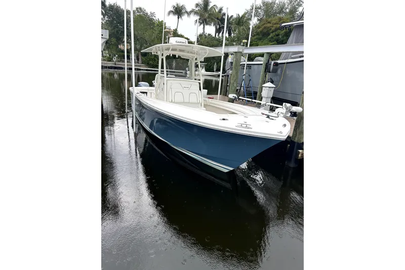 The Image of 2016 Regulator 28 Forward Seating boat docked in a serene marina setting. - 0
