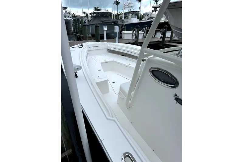 Slide: The Image of 2016 Regulator 28 Forward Seating boat docked, showcasing spacious deck and sleek design. - 5