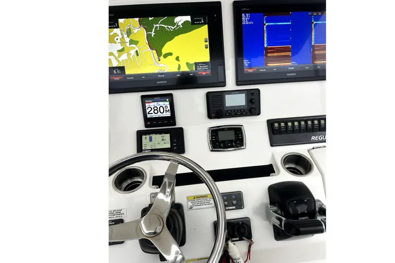 Slide: The Image of Control panel of a 2016 Regulator 28 Forward Seating boat with Garmin displays. - 7