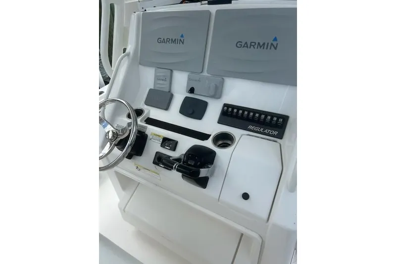 Slide: The Image of Control panel of a 2016 Regulator 28 Forward Seating boat with Garmin displays. - 8