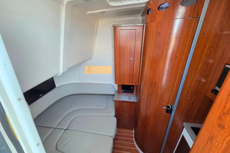 Slide: The Image of Luxurious interior of 2016 Regulator 41 boat with wood paneling and cushioned seating. - 12