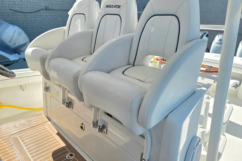 Slide: The Image of Luxury seating on a 2016 Regulator 41 boat, featuring white cushioned chairs. - 16