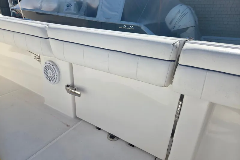 Slide: The Image of 2016 Regulator 41 boat interior with white cushioned seating and speaker. - 17