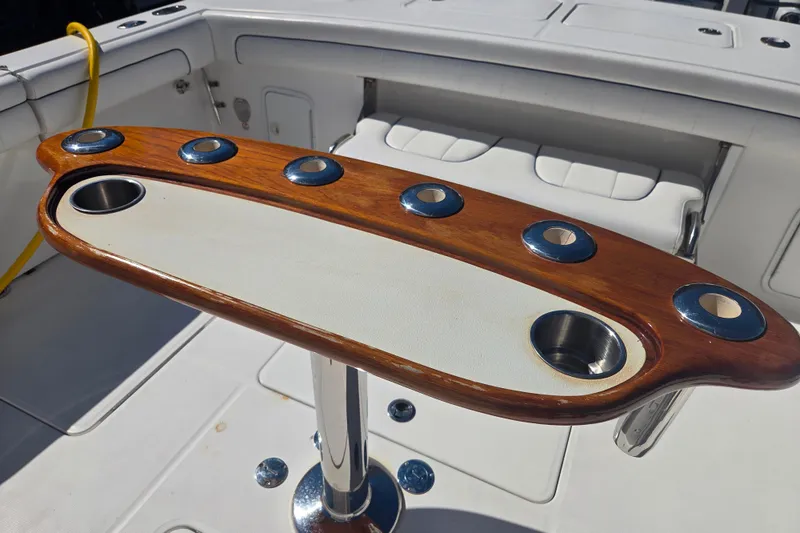 Slide: The Image of Wooden rod holder on 2016 Regulator 41 boat deck, featuring multiple cup holders. - 18